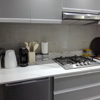 a kitchen with a stove and a counter top at Luxury Apartment Pool&Private Beach in Hurghada