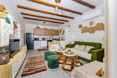 a living room with a couch and a table at Exclusive Heated Pool Chalet for a Luxury in Hurghada