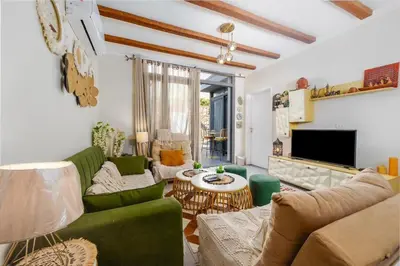 a living room with green furniture and a tv at Exclusive Heated Pool Chalet for a Luxury in Hurghada
