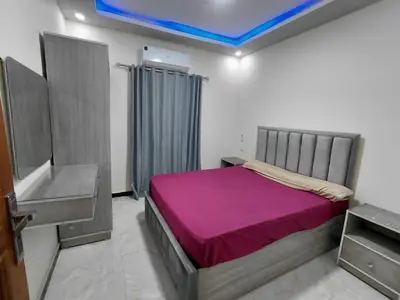 a bedroom with a bed with a purple blanket at شقق للايحار وشقق للبيع داخل الغردقه in Hurghada