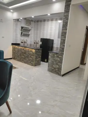 a room with a kitchen with a counter and a refrigerator at شقق للايحار وشقق للبيع داخل الغردقه in Hurghada
