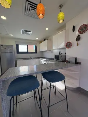 a kitchen with two blue stools at a counter at Luxury 2 BR Villa with garden - Baywest - somabay in Hurghada