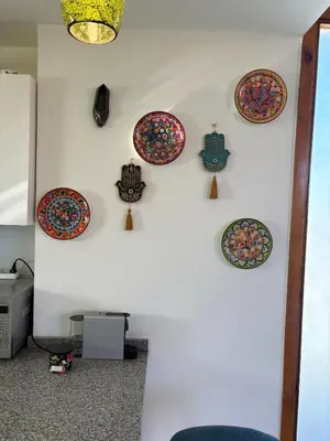 a wall with plates on a white wall at Luxury 2 BR Villa with garden - Baywest - somabay in Hurghada