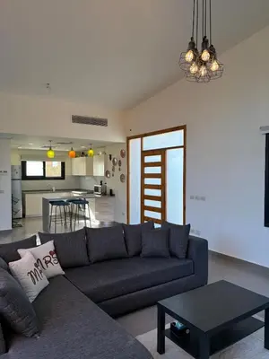 a living room with a couch and a table at Luxury 2 BR Villa with garden - Baywest - somabay in Hurghada