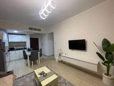 a living room with a table and a tv on the wall at Mark one bedroom sea view in Hurghada