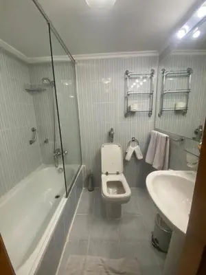 a bathroom with a tub and a toilet and a sink at tarot and tamr and sun rise nile cruises in Luxor