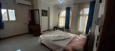 a bedroom with a bed in a room with windows at Apartment with Balcony in Luxor