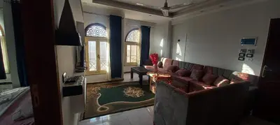 a living room with a couch and a table at Apartment with Balcony in Luxor