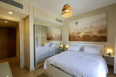 a bedroom with two beds and a painting on the wall at Mangroovy Beach Front - 1 BR - Free Beach & Pool access in Hurghada