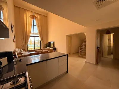 a large kitchen with a counter and a living room at El Gouna Ancient Sand Villa 3 Bedroom & Nanny in Hurghada