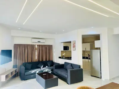 a living room with a blue couch and a refrigerator at villa sky in Hurghada