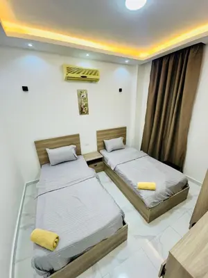 a room with two beds in it with a window at villa sky in Hurghada