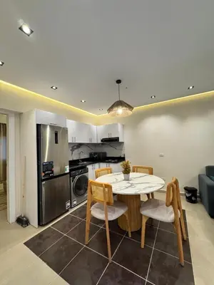 a kitchen and dining room with a table and chairs at Karma in Hurghada