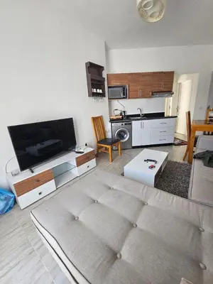 a living room with a large flat screen tv at Aqua palms resort 2 bed flat C409 in Hurghada