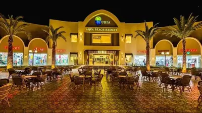 a restaurant with tables and chairs in front of a building at شاليه فندقى in Hurghada