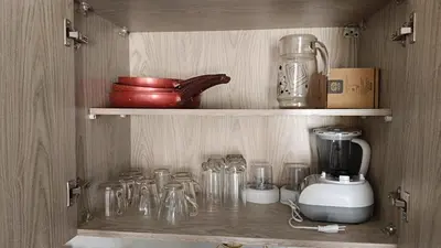 a cupboard with a blender and other glass items at شاليه فندقى in Hurghada