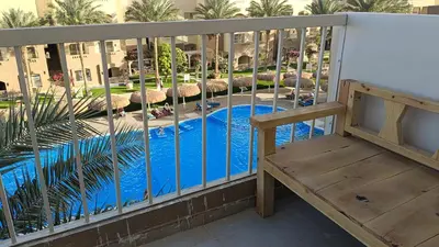 a balcony with a view of a swimming pool at شاليه فندقى in Hurghada