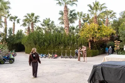 a woman standing in a courtyard with palm trees at Mirage Bay Resort Hurghada C-781 in Hurghada