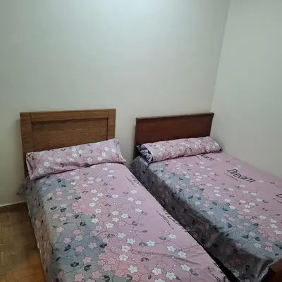 two beds sitting next to each other in a bedroom at Julia's Guest House in Shellal