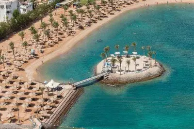 an aerial view of a beach with palm trees and umbrellas at Mirage Bay Resort Hurghada B-794 in Hurghada