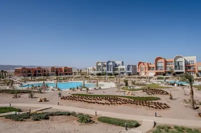 a resort with two swimming pools and buildings at Signature Kamaran duplex 1 bed pool & views in Hurghada
