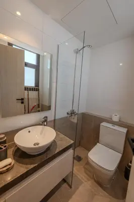 a bathroom with a toilet and a sink and a shower at Signature Kamaran duplex 1 bed pool & views in Hurghada