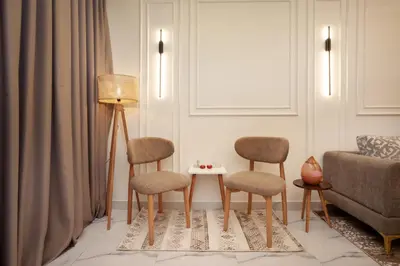 a living room with two chairs and a table at Luxor Nile View Apartment Marah 1 in Luxor