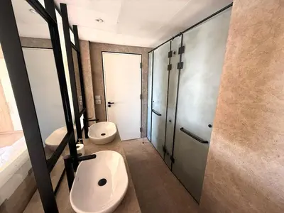 a bathroom with two sinks and two toilets at Pool front Mesca Cabana Minutes to Sandy Beach in Soma bay in Hurghada