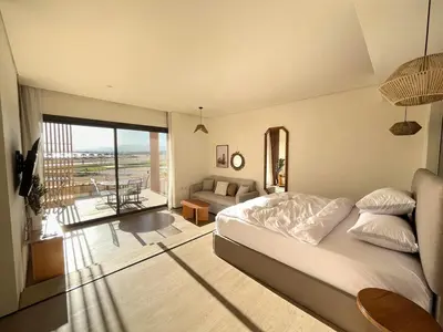 a bedroom with a bed and a living room at Beachfront Cabana Steps to Sandy Beach And Pool in Soma bay in Hurghada