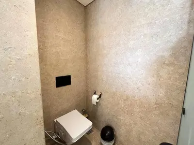 a bathroom with a white toilet in a room at Beachfront Cabana Steps to Sandy Beach And Pool in Soma bay in Hurghada