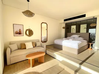 a bedroom with a bed and a couch at Beachfront Cabana Steps to Sandy Beach And Pool in Soma bay in Hurghada