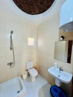 a bathroom with a toilet and a sink and a tub at 2 bedroom flat with balcony in Hurghada