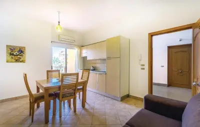 a kitchen and dining room with a table and chairs at Iris Holiday Apartament in Hurghada