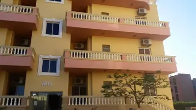 a building with balconies on the side of it at Iris Holiday Apartament in Hurghada