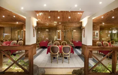a dining room with red tables and chairs at Pyramisa Hotel Luxor in Luxor