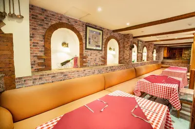 a restaurant with two tables with red and white tablecloths at Pyramisa Hotel Luxor in Luxor