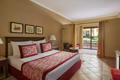 a hotel room with a bed and a balcony at JAZ Solaya in Coraya Bay