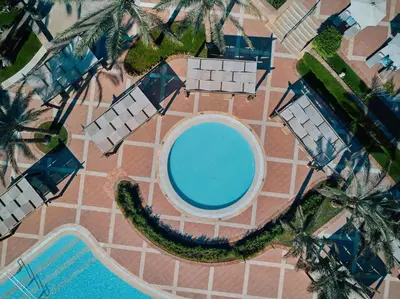 an overhead view of a swimming pool with palm trees at JAZ Makadi Star & Spa in Hurghada