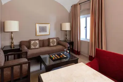 a living room with a couch and a table at JAZ Makadi Oasis Resort in Hurghada