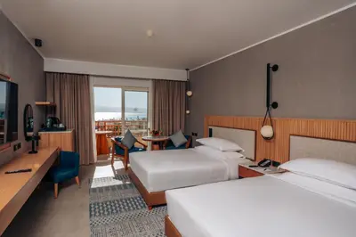 a hotel room with two beds and a television at Sheraton Soma Bay Resort in Hurghada