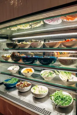 a display case filled with different types of food at Sheraton Soma Bay Resort in Hurghada