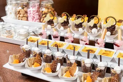 a buffet of desserts and milkshakes on a table at Three Corners Rihana Resort El Gouna in Hurghada