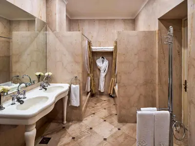 a bathroom with a sink and a shower at Sofitel Winter Palace Luxor in Luxor