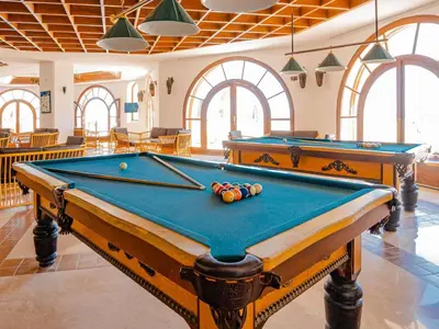 a pool table in a large room with windows at Mercure Hurghada Hotel in Hurghada
