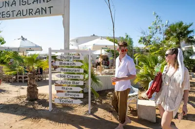 a man and a woman standing next to a sign at Three Corners Ocean View El Gouna - Adults Only in Hurghada