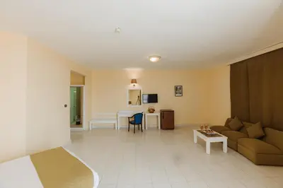 a living room with a couch and a table at Empire Hotel Aqua Park in Hurghada