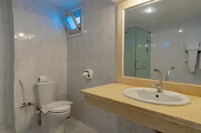 a bathroom with a toilet and a sink and a mirror at Empire Beach Aqua Park in Hurghada