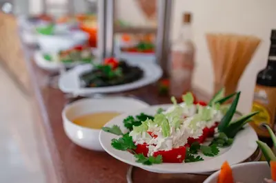 a row of plates of food on a counter at Empire Beach Aqua Park in Hurghada