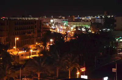 a view of a city at night with lights at Elaria Hotel Hurgada in Hurghada