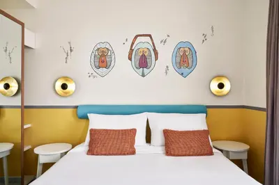 a bedroom with a bed and some pictures on the wall at Turtle's Inn Hotel in Hurghada